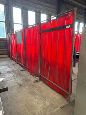 a room that has a red curtain in the middle of it