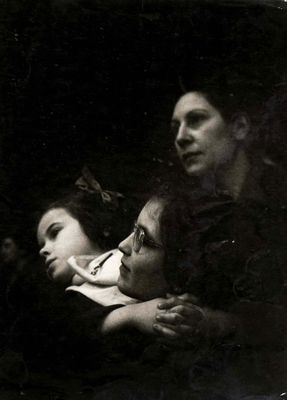 a black and white photo of two women and a man