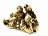 a figurine of two people sitting on a blanket