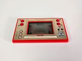 a small red game console sitting on a white surface