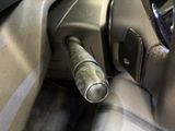 a close up of a car seat with a metal pipe sticking out of it