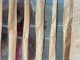 five knives and a knife sharper on a wooden table