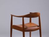 an image of a wooden chair with a brown leather seat