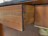 a close up of a wooden cabinet with a black top