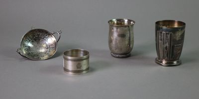 several silver cups and spoons are lined up on a table