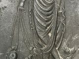 an image of a silver coin with a woman holding a fish