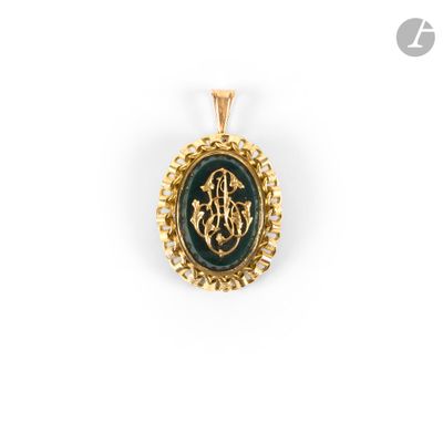 a gold pendant with a green stone and a gold chain