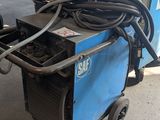 an image of a welding machine in a garage with other equipment