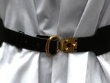 a black belt with gold buckles on a white dress