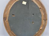 an image of a round wooden mirror with holes in the middle