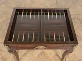 a wooden table with a glass top with a game set in it