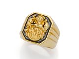 a close up of a gold ring with a coat of arms on it