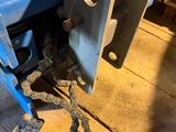 a chain attached to the back of a blue tractor