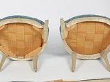 pair of mid - century style chairs with upholstered seats on wooden legs