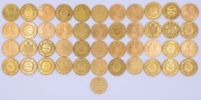 a close up of a pile of gold coins on a white surface