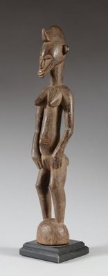 an image of a wooden statue of a man standing on a pedestal