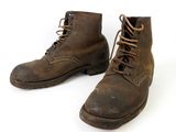 pair of brown leather boots with laces on a white background
