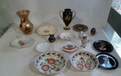 a table with a lot of different plates and vases on it