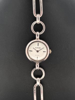 AURORE. Montre bracelet de dame en argent, boitier rond à ca…