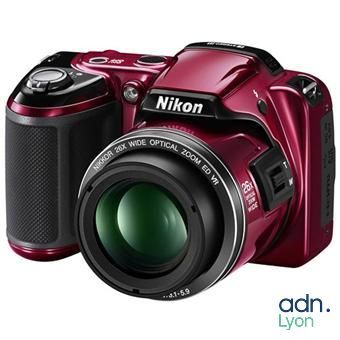 the nik digital camera is red and has a lens on it
