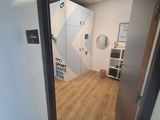 a room with a door and a mirror on the wall