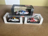 three boxed toy cars are sitting on a table next to each other