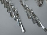 a lot of forks and spoons that are on the table