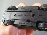 a person holding a small toy car in their hand