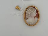 an image of a picture of a woman in a gold frame on a white surface