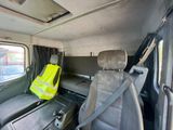 two seats in the back of a van with a safety vest on