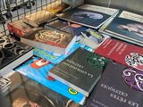 many books that are on a table in a cage