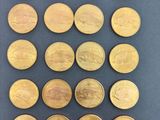 a bunch of coins sitting on top of a table next to each other