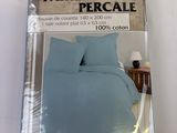 packaging of a bed with a blue comforter and a pillow
