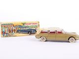 a toy car and a box of toys on a white surface