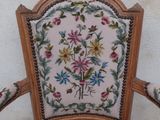 a chair that has a floral pattern on the back of it