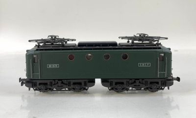 a green train on a white surface with a white background
