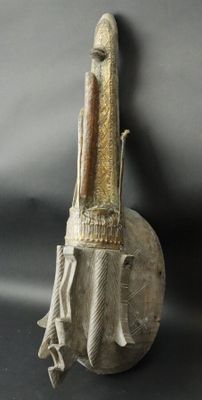 statue of a man holding a knife on top of a metal object