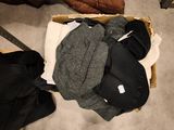 a person standing on the floor next to a pile of clothes