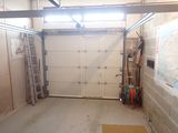 a room with a garage door and a wall with a map on it
