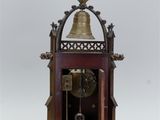 a clock that has a bell on top of it