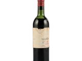 bottle of red wine with a red cap on a white background