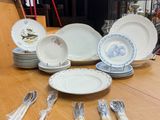a table with a lot of plates and silverware on it