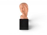 an image of a sculpture of a woman ' s head on a black stand