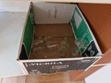 a box with a bottle inside of it sitting on the floor