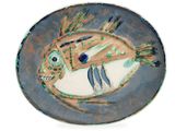 a plate with a fish design on it on a white background