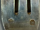 a metal fork with a hole in the middle of it