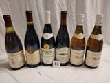 several bottles of wine are lined up on a table