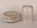two pieces of glass sitting next to each other on a table