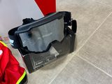 a helmet and goggles on the floor next to a box