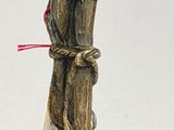 a statue of a frog sitting on top of a pole